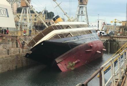 90m Corsair charter superyacht Nero listed to port in dry dock in Genova